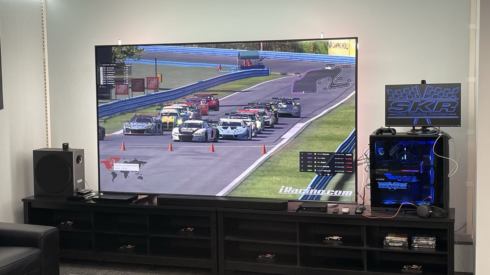 Big-screen iRacing demo showing GT3 cars at Watkins Glen