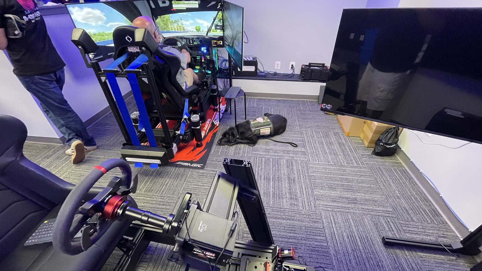 Member driving on a full-motion sim rig