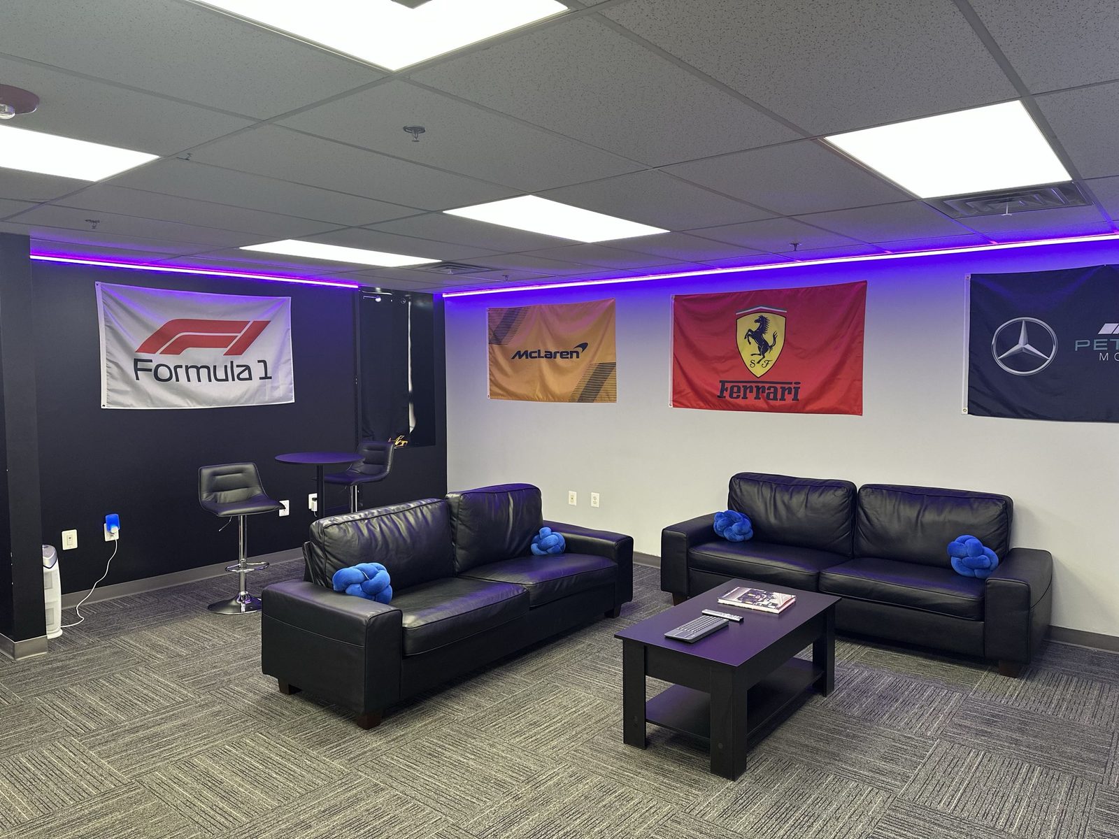 Lounge area with leather couches and racing flags