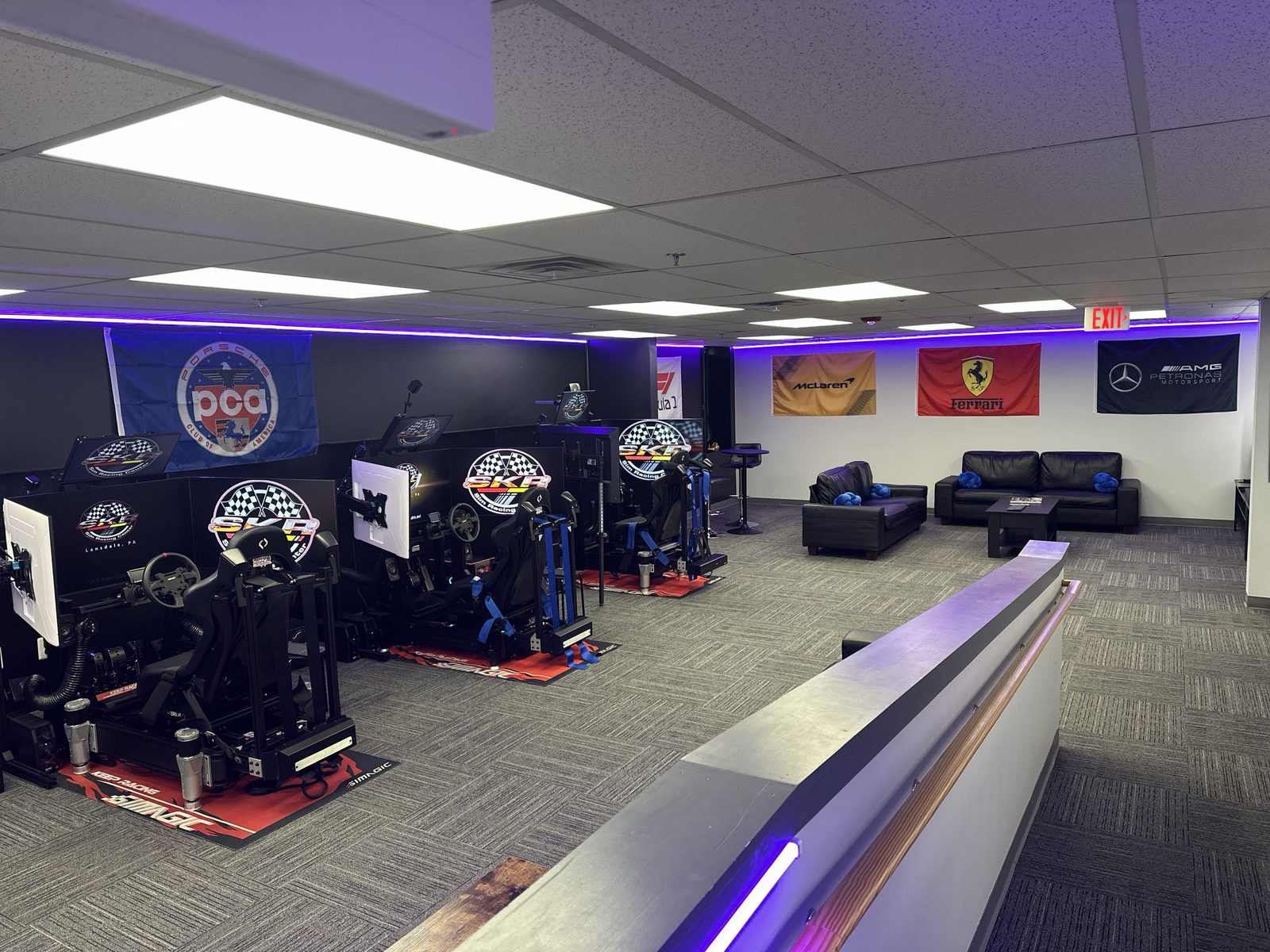 Main sim bay with several full-motion sim racing rigs lined up