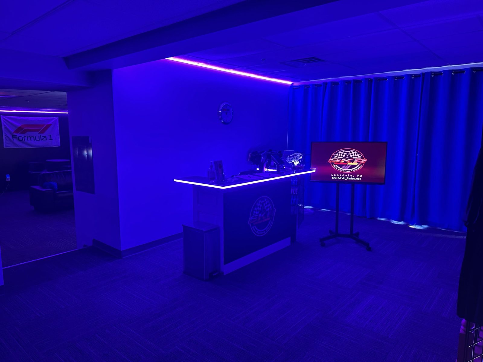 Reception desk with SKR branding under blue lighting